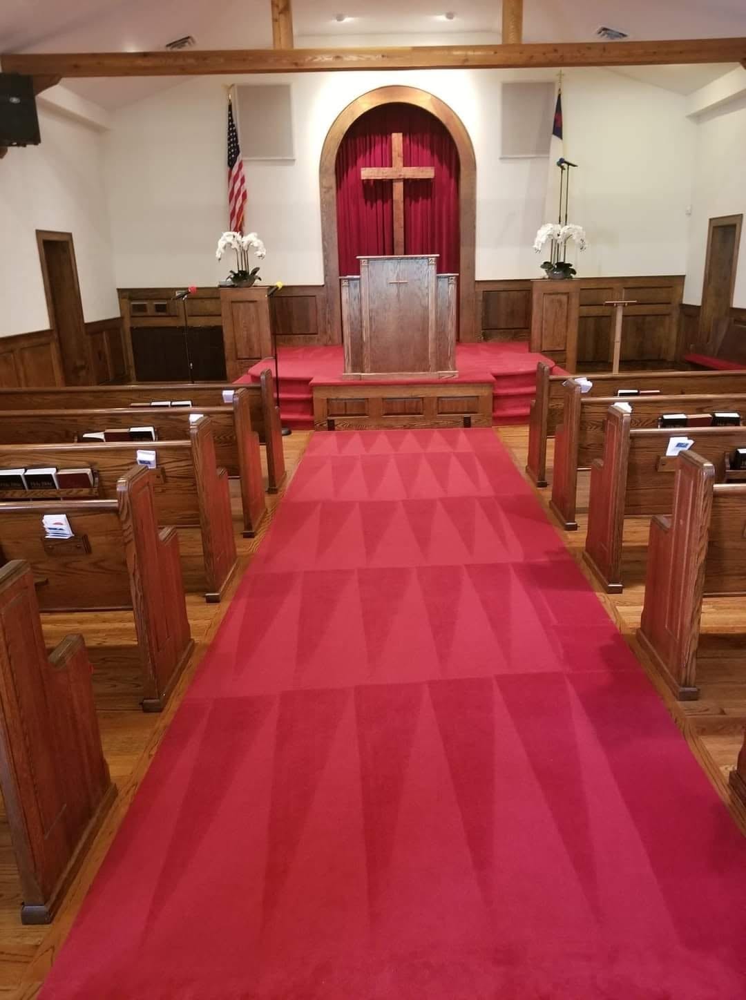 Same church after carpet cleaning, finished red aisle carpet